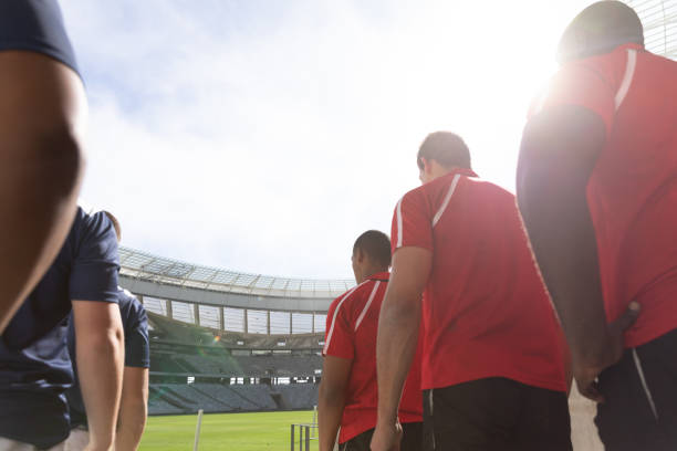 istock Male rugby players standing in a row at stadium for match 1159629263
