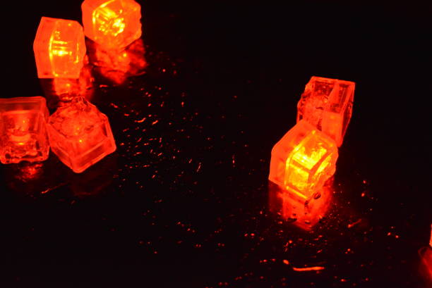 istock Original bright red glowing plastic cubes in total darkness. Awesome background, hellish and creepy red color, mixed glowing ice cubes. 1159629288