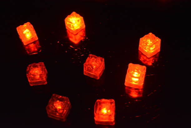 istock Original bright red glowing plastic cubes in total darkness. Awesome background, hellish and creepy red color, mixed glowing ice cubes. 1159629348