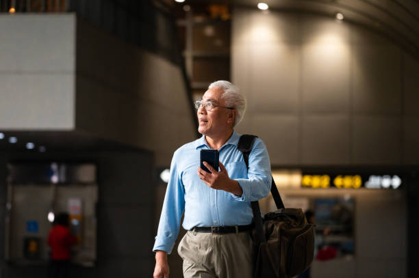 istock Businessman with cellphone walking at subway 1159630301