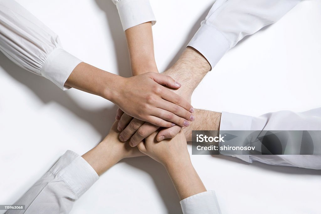 All for one Isolated on white four joint human hands in white t-shirts Community Stock Photo