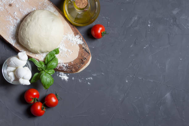 istock Raw pizza ingredients on the grey background with copy space, you can put your image or inscription on the right 1159635537
