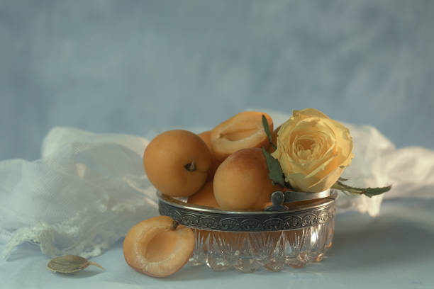 Still life with ripe apricots and roses