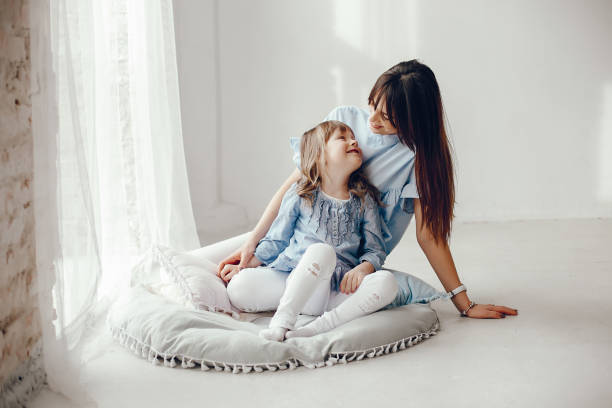 Mother with little daughter in a room stock photo