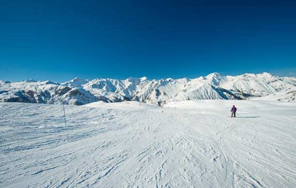 istock Skiers on a piste in alpine ski resort 1159637537