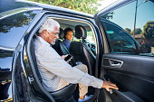 Senior Black Man Gets in Taxi
