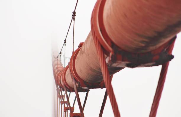 golden gate bridge main cable disappearing into thick fog - bridge golden gate bridge cloud san francisco bay imagens e fotografias de stock