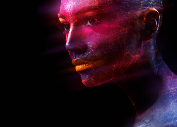 istock Crop sensual woman with colored face in dark 1159640358