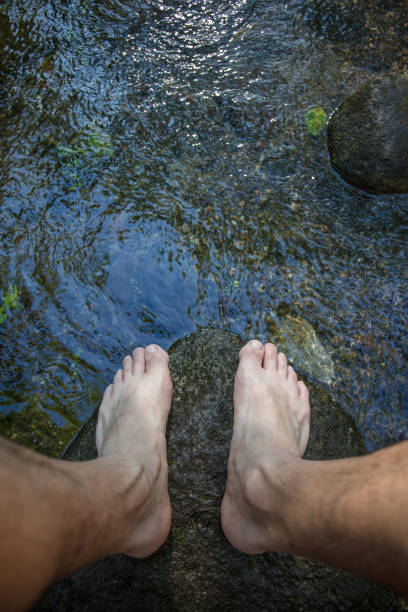 istock Naked man feet in the wild 1159641430