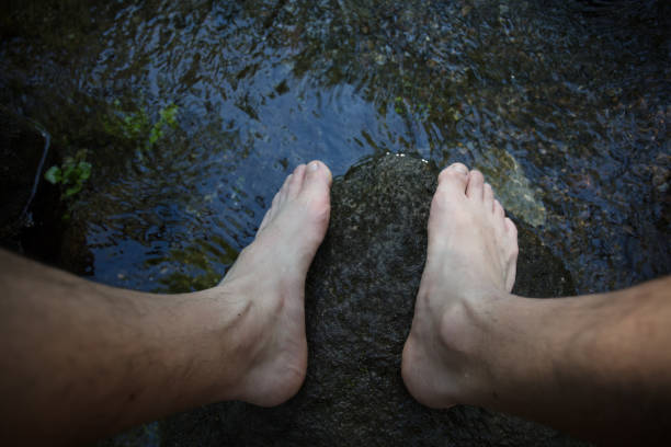 istock Naked man feet in the wild 1159641489