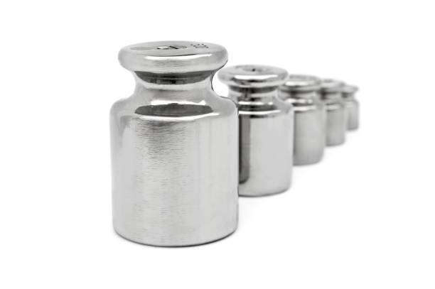 istock Row of weights for laboratory scales on white. 1159641510