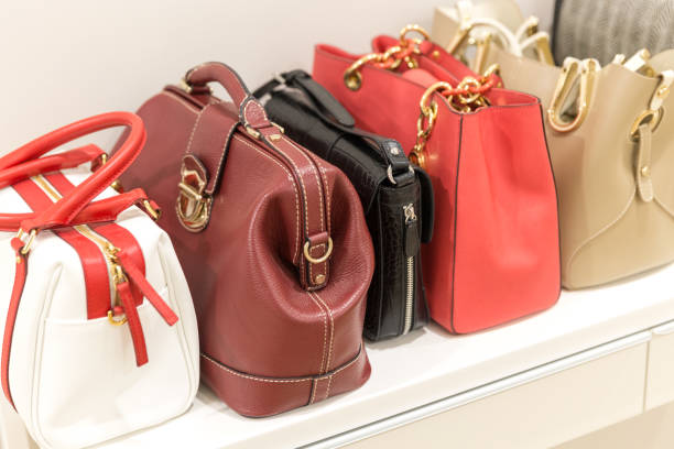 istock Collection of handbags standing in a row 1159642696