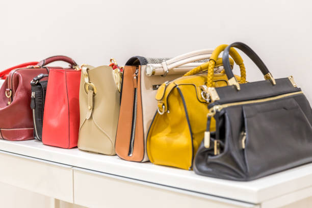 istock Collection of handbags standing in a row 1159642745