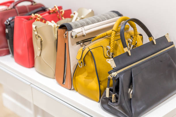 istock Collection of handbags standing in a row 1159642857