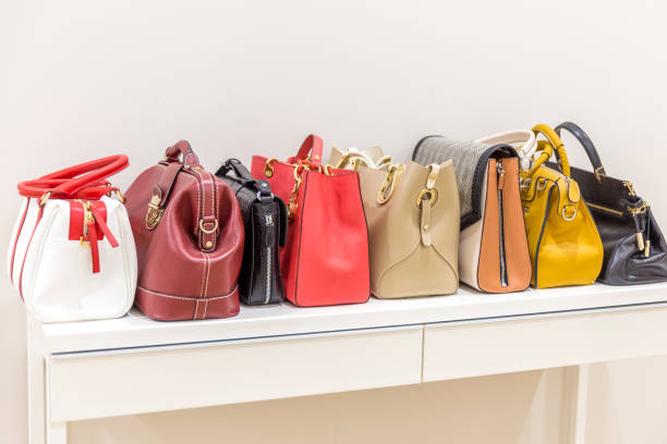 istock Collection of handbags standing in a row 1159642906