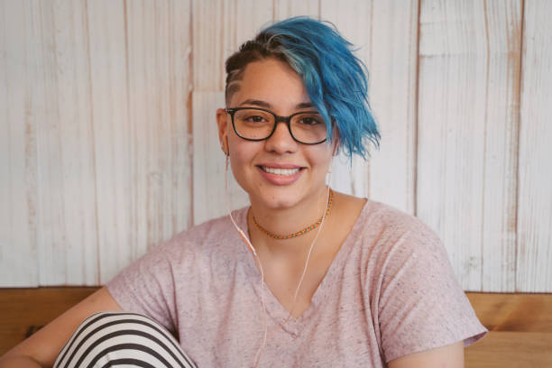 Stylish blue short hair with a lesbian cut. portrait of a young cheerful woman with urban style. androgyn stock pictures, royalty-free photos & images
