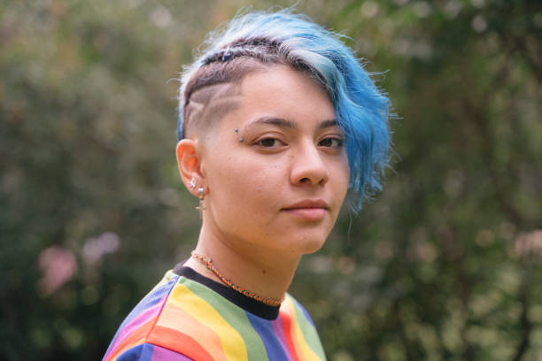 Equal rights for all sexual orientations. Young cheerful woman with expression of sadness and blue short hair. transgender person photos stock pictures, royalty-free photos & images