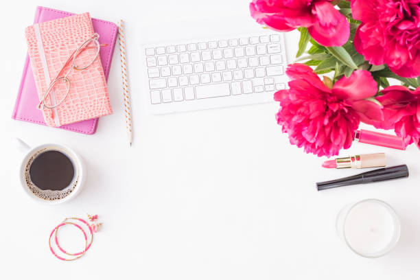istock Flat lay blogger or freelancer workspace with a notebook, keyboard, red peonies on a white background 1159644873