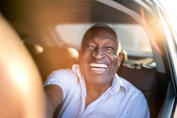istock Smiling senior man taking a selfie in a car 1159645759