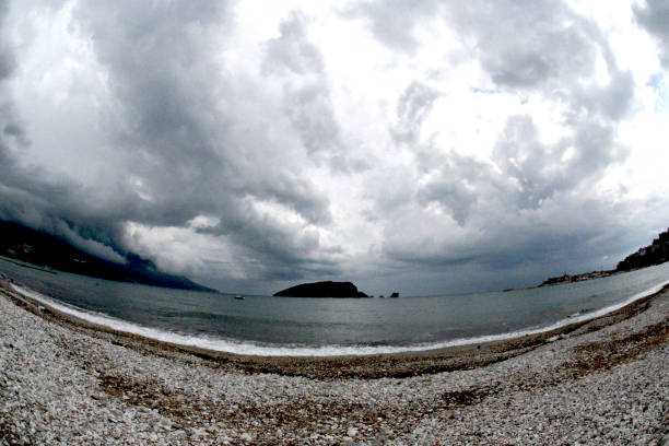 istock Sandy beach at dawn, under the stormy sky 1159646518