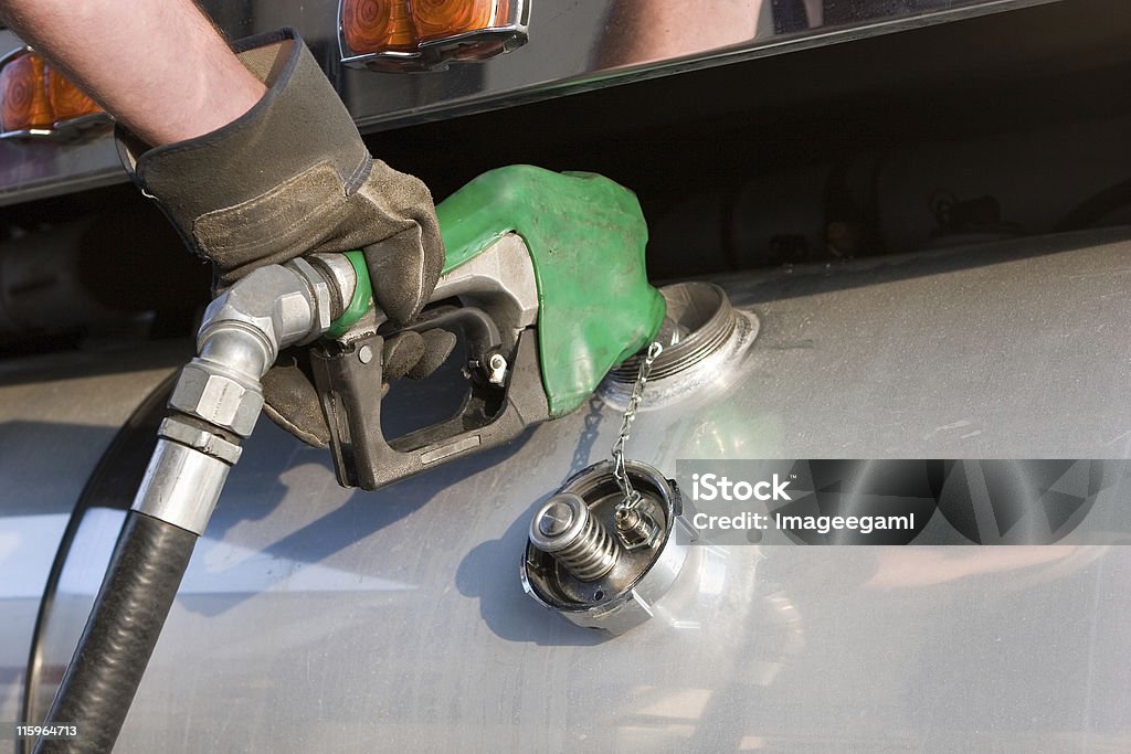 A man fuelling up a freight transport truck Diesel Fuel Pump, Semi Truck Diesel Fuel Stock Photo