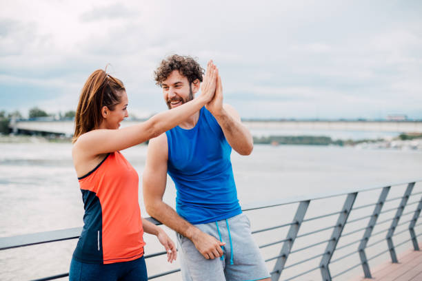 istock Athletic couple giving high-five ton each other 1159647813