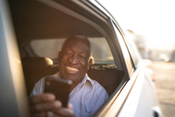 istock Happy senior man using phone in the car 1159648462