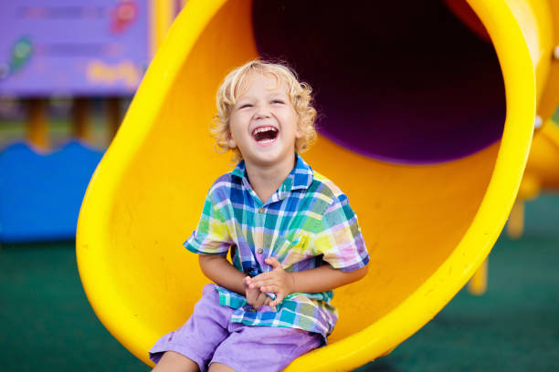 istock Child on playground. Kids play outdoor. 1159648529