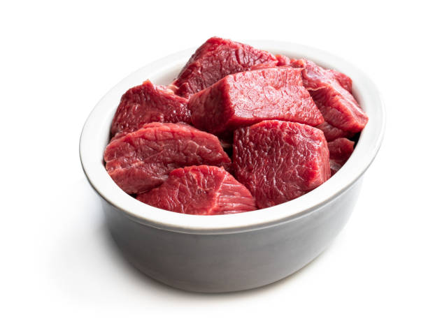 istock Sliced raw beef in ceramic bowl isolated on white 1159649872