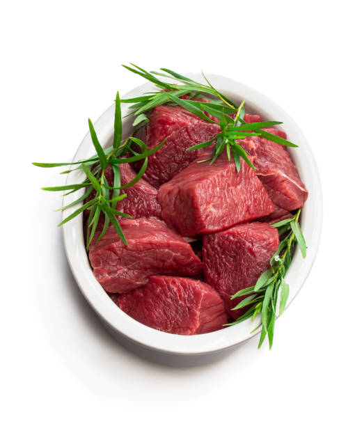 istock Sliced raw beef with tarragon herb in ceramic bowl isolated on white 1159649887