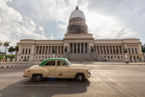 Havana, Cuba - May 14, 2019: Classic Old Taxi Car in the streets of the beautiful Old Havana City during a vibrant and bright sunny morning.