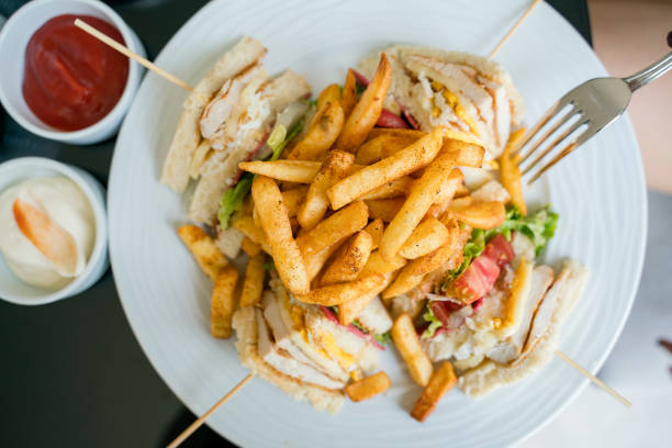 french fries chips with club sandwich on plate, directly above - club sandwich sandwich french fries turkey imagens e fotografias de stock