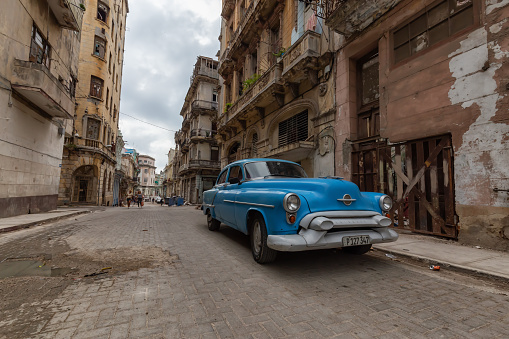 Havana, Cuba - May 14, 2019: Classic Old Car in the streets of the beautiful Old Havana City during a cloudy day.