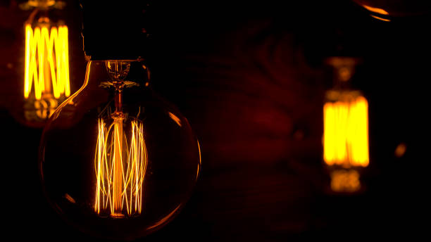 istock Close-Up Edison Light Bulb Slowly Lights Up On A Beautiful Blurred Background. 1159652734