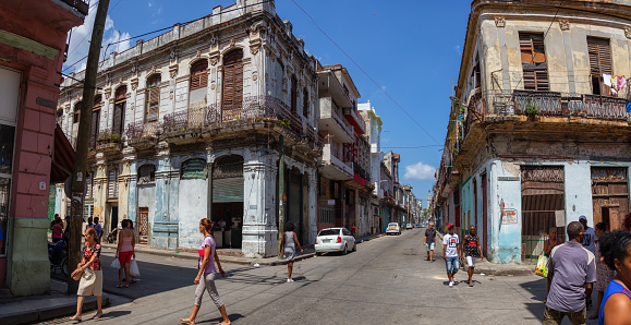 Havana, Cuba - May 19, 2019: Panoramic Street view of the disadvantaged residential neighborhood in the Old Havana City, Capital of Cuba, during a bright and sunny day.
