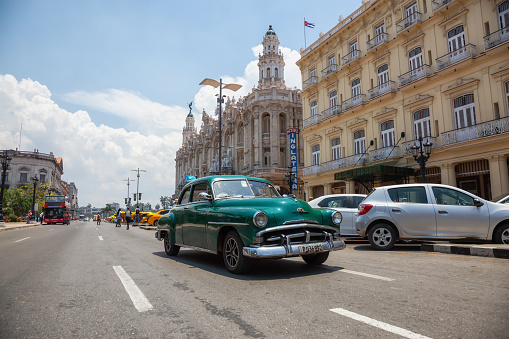 Havana, Cuba - May 19, 2019: Classic Old American Car in the streets of the Old Havana City during a vibrant and bright sunny day.