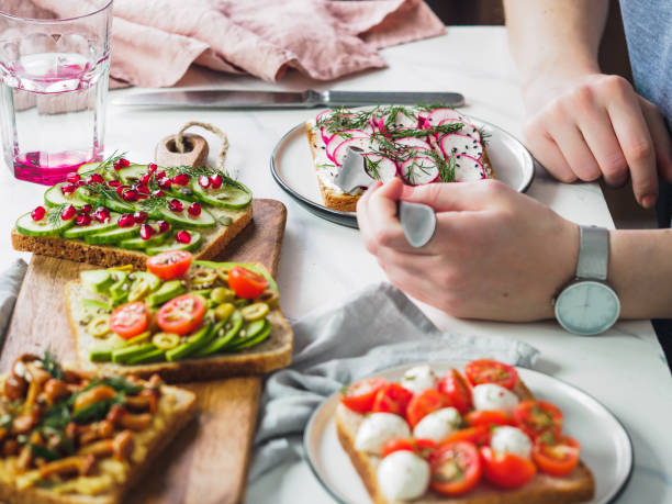 istock Female hands on vegetarian tablesettings 1159653806
