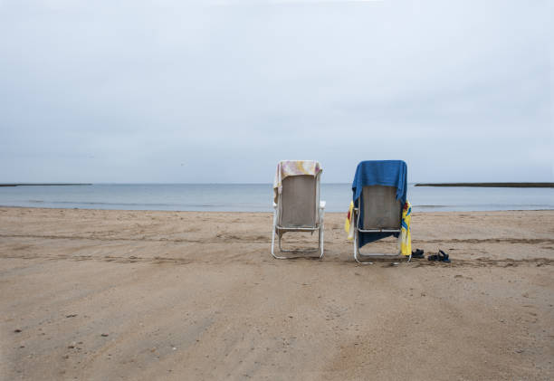 Empty hammocks on the beach with colorful towels waiting for bath time