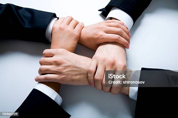 Four Hands Joined Together In Harmony Stock Photo - Download Image Now - Adult, Agreement, Authority