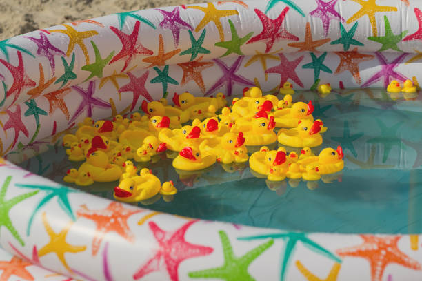 istock Many rubber yellow toy ducks floating in children's pool 1159657664