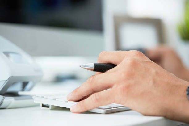 istock Man's hands holding a credit card and using computer keyboard for online shopping or payment. 1159657969