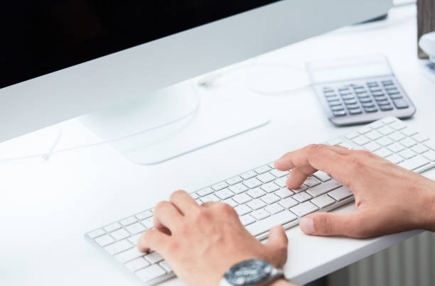 istock Close up of male hands typing on computer keyboard. Businessman using computer keyboard. Blogger, journalist writing new article. 1159657972