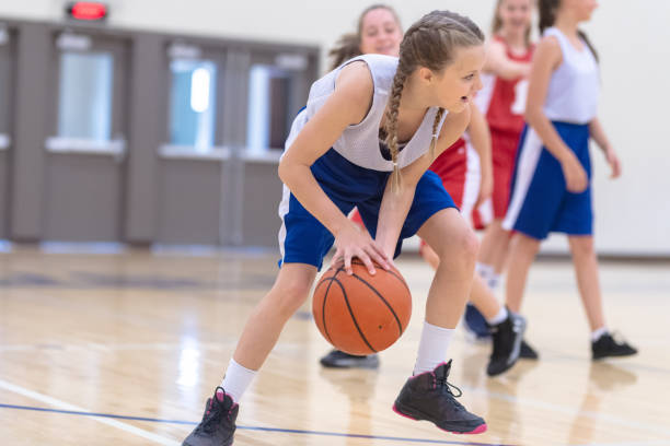 istock Elementary girls basketball practice 1159658336