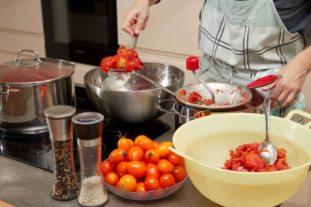 istock housewife in modern kitchen at tomato cooking 1159659384