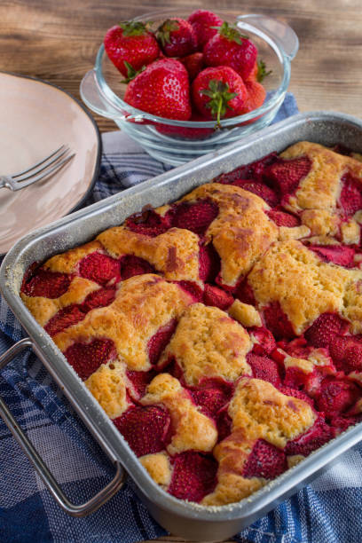 istock Yeast cake with strawberry in a mold. 1159659728