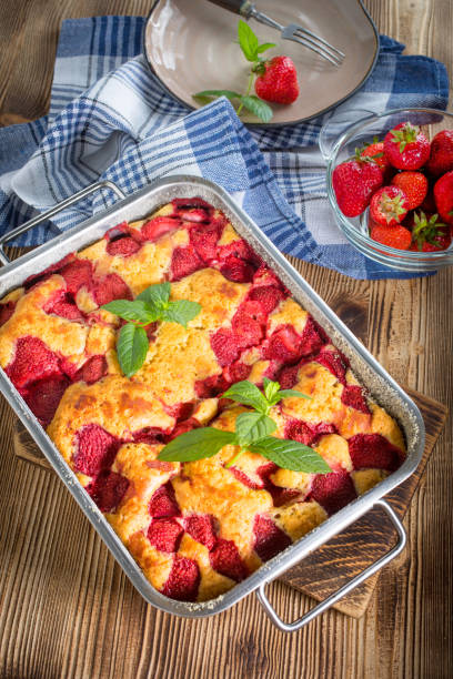 istock Yeast cake with strawberry in a mold. 1159659888