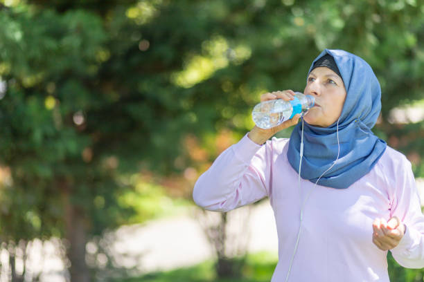 istock muslim Woman taking a break from running 1159660065