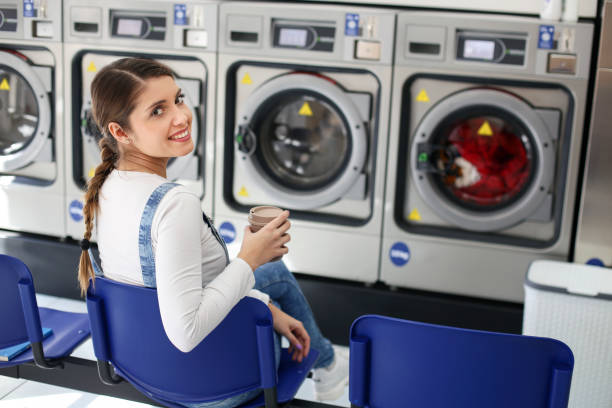 istock Young woman at a laundromat 1159661018
