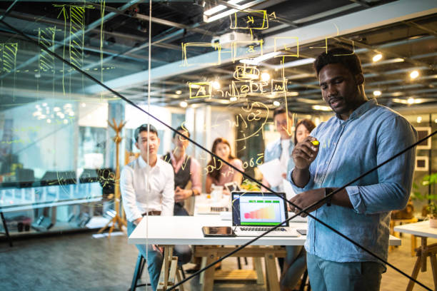 istock Haitian businessman writing On Transparent Wipe Board 1159663890