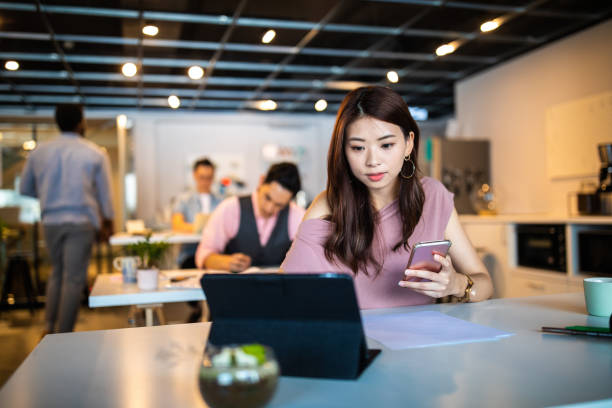 istock Asian businesswoman using portable technology in the office 1159664068